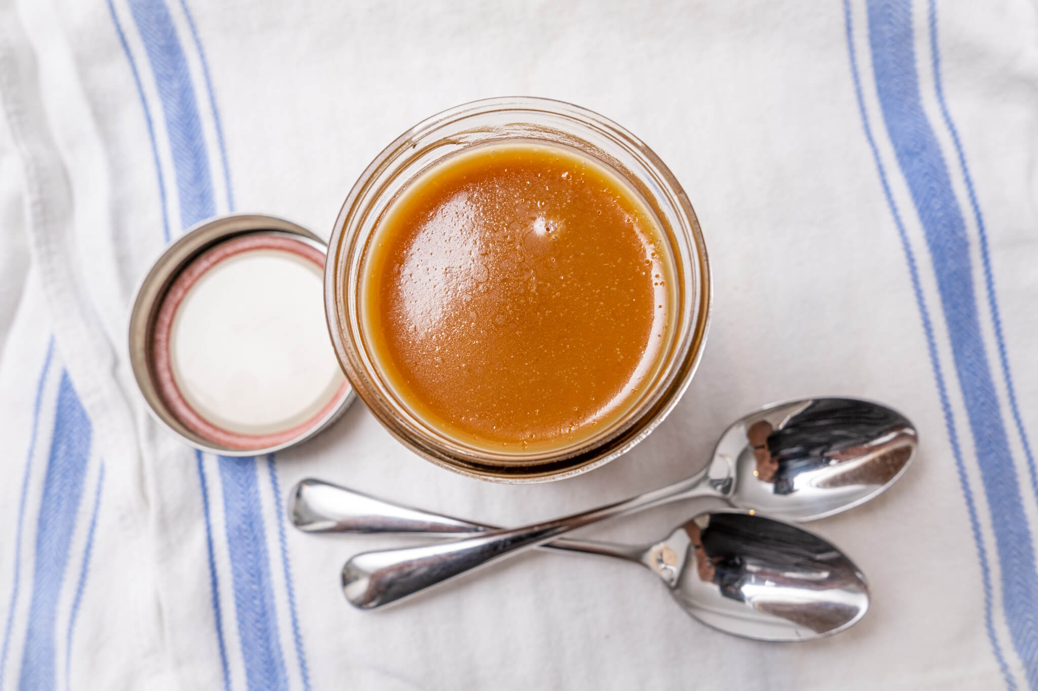 A mason jar of vegan salted caramel sauce photographed from above