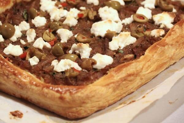 Olive tapenade tart with caramelized onions and ricotta cheese