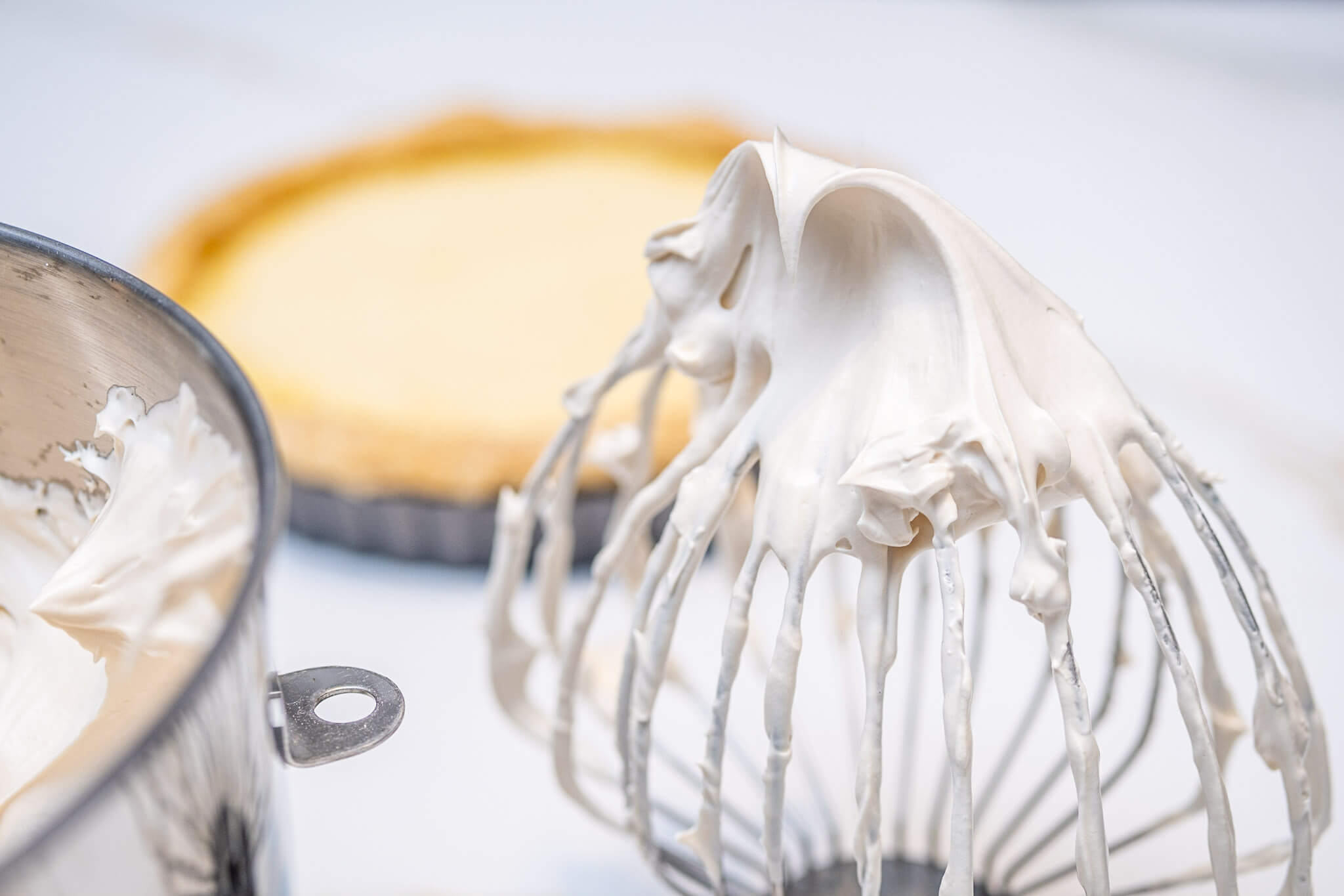 Wire whisk with Italian meringue for a lemon-lime meringue tart