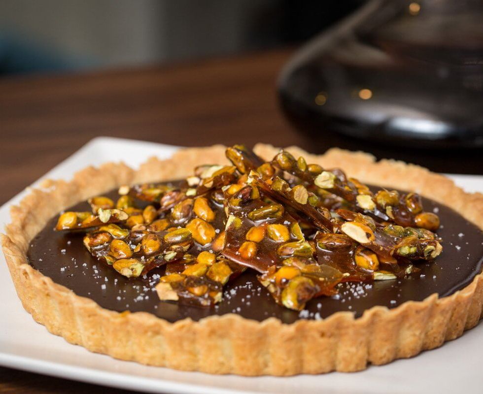 Chocolate tart with salted caramelized pistachios