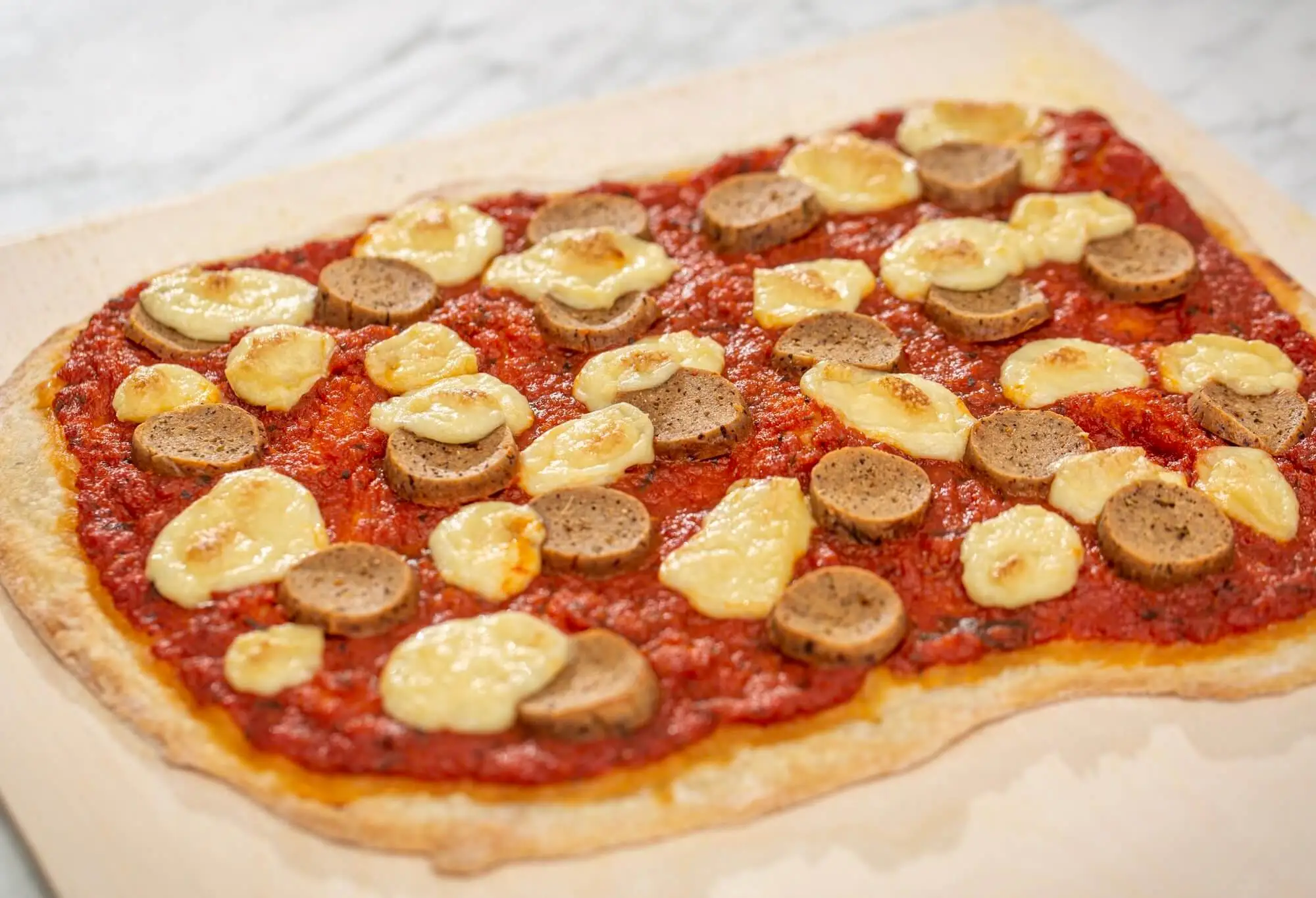 Vegan pizza with seitan Italian sausage and cashew mozzarella cheese