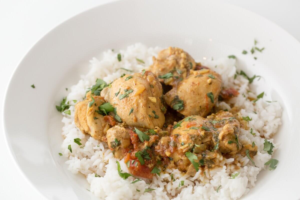 Sindhi chicken curry with tomatoes and cilantro, served on white rice