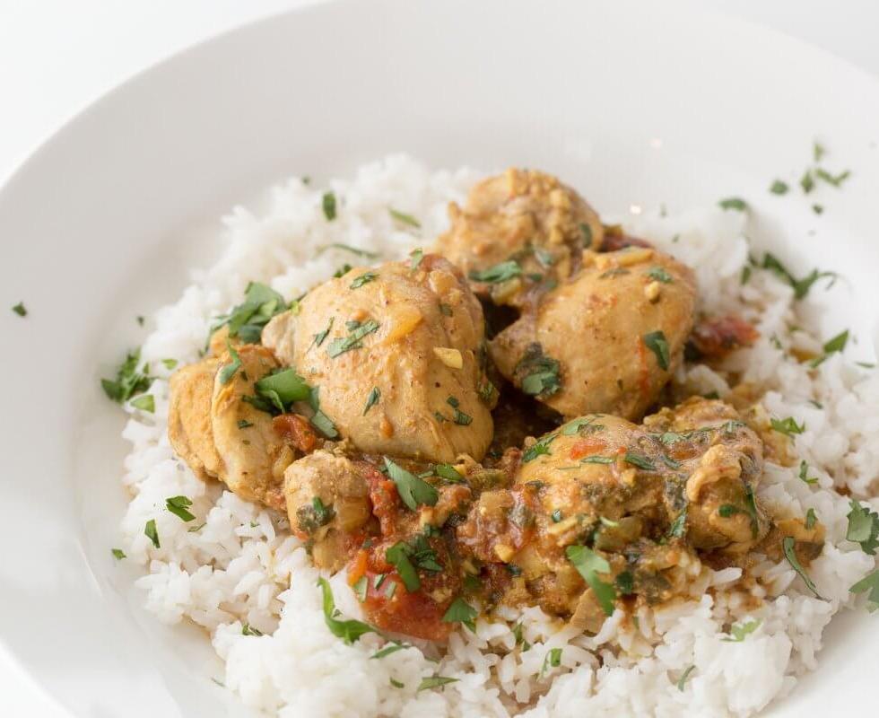 Sindhi chicken curry with tomatoes and cilantro, served on white rice