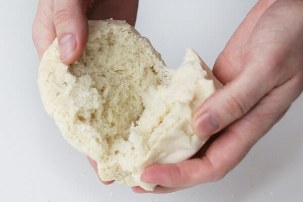 Splitting a freshly-baked sourdough English muffin