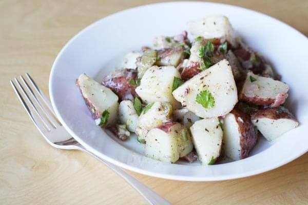 Potato salad with bacon, pickles and caraway seeds