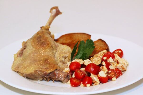 Homemade duck confit with toast and tomato-feta salad