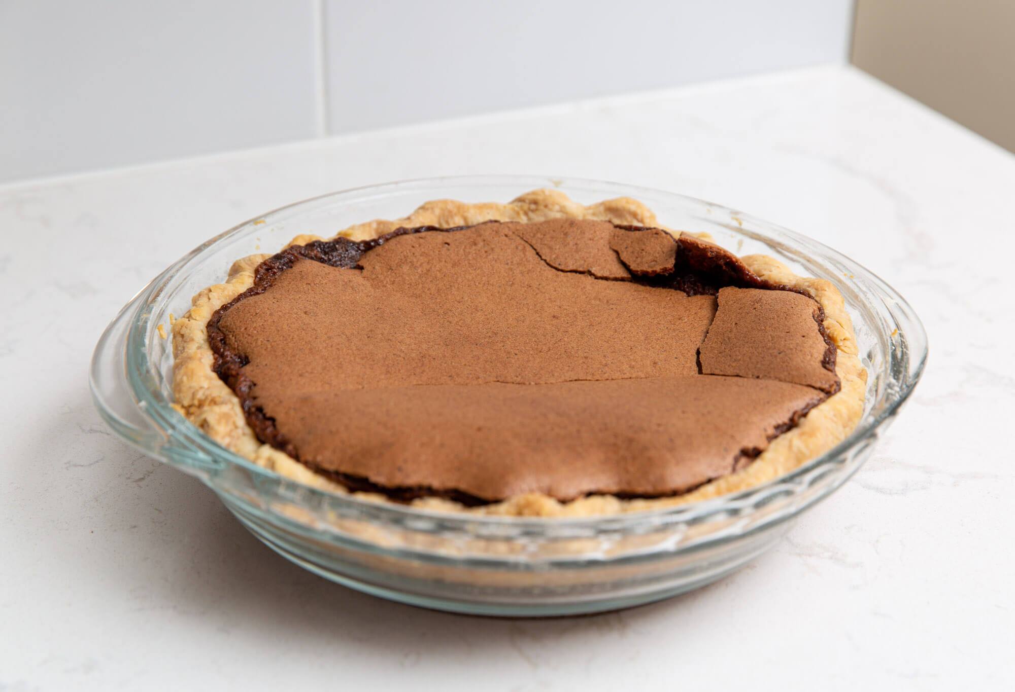 Chocolate chess pie on a white marble countertop